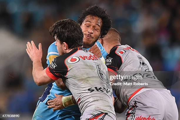 Agnatius Paasi of the Titans is tackled during the round 15 NRL match between the Gold Coast Titans and the New Zealand Warriors at Cbus Super...