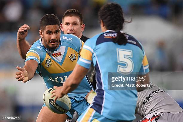 Nene MacDonald of the Titans offloads the ball in the tackle during the round 15 NRL match between the Gold Coast Titans and the New Zealand Warriors...