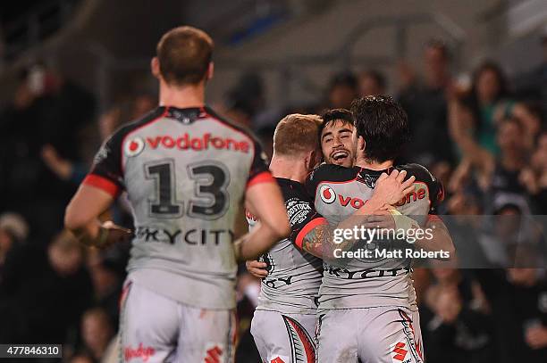 Shaun Johnson of the Warriors celebrates scoring a try with team mates during the round 15 NRL match between the Gold Coast Titans and the New...