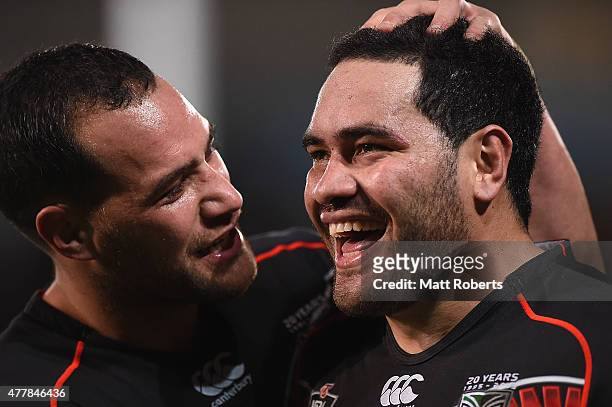 Konrad Hurrell of the Warriors celebrates scoring a try with team mate Bodene Thompson during the round 15 NRL match between the Gold Coast Titans...