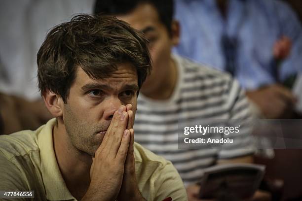 People attend a vigil at the College of Charleston TD Arena for the nine victims of shooting at the Emanuel African Methodist Episcopal Church in...