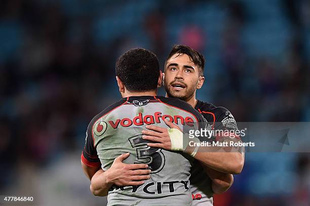 Shaun Johnson of the Warriors celebrates victory with Konrad Hurrell during the round 15 NRL match between the Gold Coast Titans and the New Zealand...