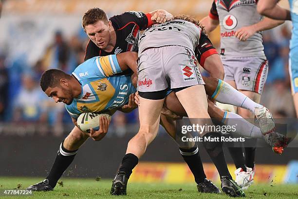 Nene MacDonald of the Titans is tackled during the round 15 NRL match between the Gold Coast Titans and the New Zealand Warriors at Cbus Super...