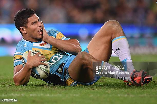 David Mead of the Titans holds his face after a tackle during the round 15 NRL match between the Gold Coast Titans and the New Zealand Warriors at...