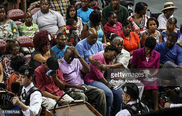 People attend a vigil at the College of Charleston TD Arena for the nine victims of shooting at the Emanuel African Methodist Episcopal Church in...
