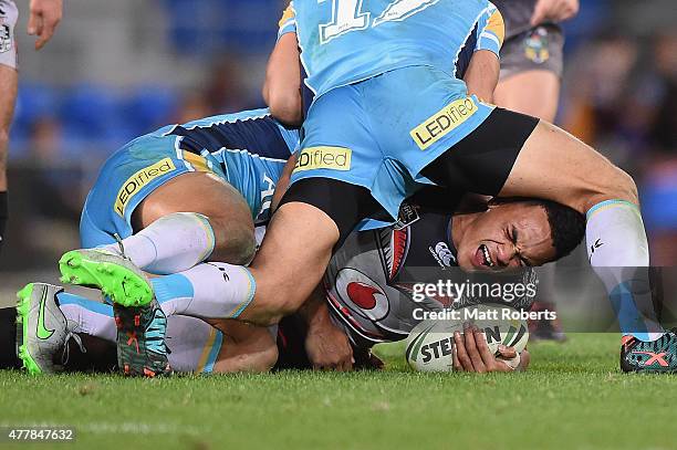 Ken Maumalo of the Warriors grimaces in the tackle during the round 15 NRL match between the Gold Coast Titans and the New Zealand Warriors at Cbus...