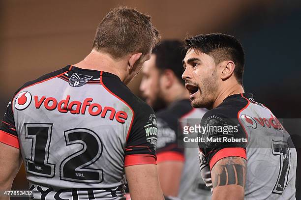 Shaun Johnson of the Warriors speaks with Ryan Hoffman during the round 15 NRL match between the Gold Coast Titans and the New Zealand Warriors at...