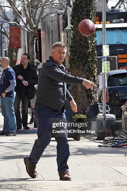 Actor Alec Baldwin is seen throwing a football on March 11, 2014 in New York City.