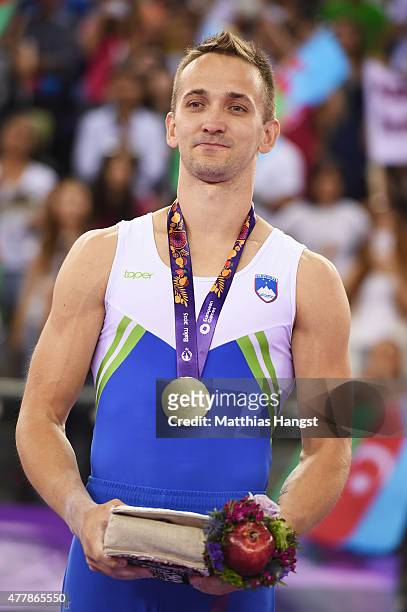 Gold medalist Saso Bertoncelj of Slovenia stands on the podium during the medal ceremony for the Men's Pommel Horse final on day eight of the Baku...
