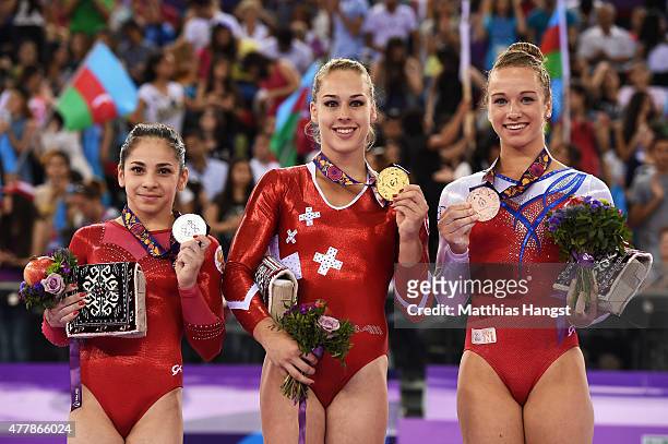 Silver medalist Seda Tutkhalyan of Russia, gold medalist Giulia Steingruber of Switzerland and bronze of Lisa Top of the Netherlands stand on the...