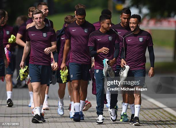 Matt Targett, Ruben Loftus-Cheek, Jesse Lingard and Nathan Redmond look on as the squad walk to training during the England U21 training session and...