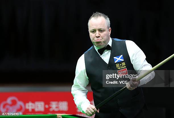 John Higgins of Scotland reacts in quarter-finals match with Stephen Maguire of Scotland against Ding Junhui and Xiao Guodong of China A on day six...
