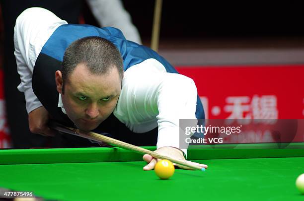 Stephen Maguire of Scotland eyes the ball in quarter-finals match with John Higgins of Scotland against Ding Junhui and Xiao Guodong of China A on...