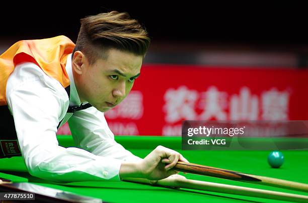 Xiao Guodong of China A plays a shot in quarter-finals match with Ding Junhui of China A against John Higgins and Stephen Maguire of Scotland on day...