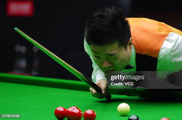Ding Junhui of China A eyes the ball in quarter-finals match with Xiao Guodong of China A against John Higgins and Stephen Maguire of Scotland on day...
