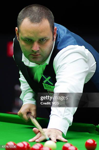 Stephen Maguire of Scotland plays a shot in quarter-finals match with John Higgins of Scotland against Ding Junhui and Xiao Guodong of China A on day...
