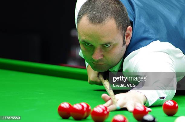 Stephen Maguire of Scotland plays a shot in quarter-finals match with John Higgins of Scotland against Ding Junhui and Xiao Guodong of China A on day...