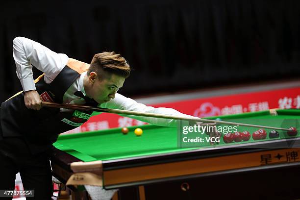 Xiao Guodong of China A plays a shot in quarter-finals match with Ding Junhui of China A against John Higgins and Stephen Maguire of Scotland on day...
