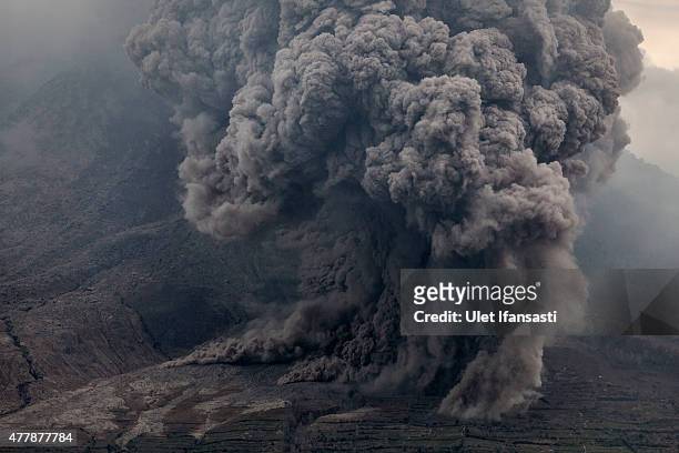Mount Sinabung spews pyroclastic smoke, seen from Tiga Kicat village on June 20, 2015 in Karo District, North Sumatra, Indonesia. According to The...