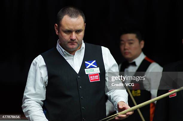Stephen Maguire of Scotland reacts in quarter-finals match with John Higgins of Scotland against Ding Junhui and Xiao Guodong of China A on day six...