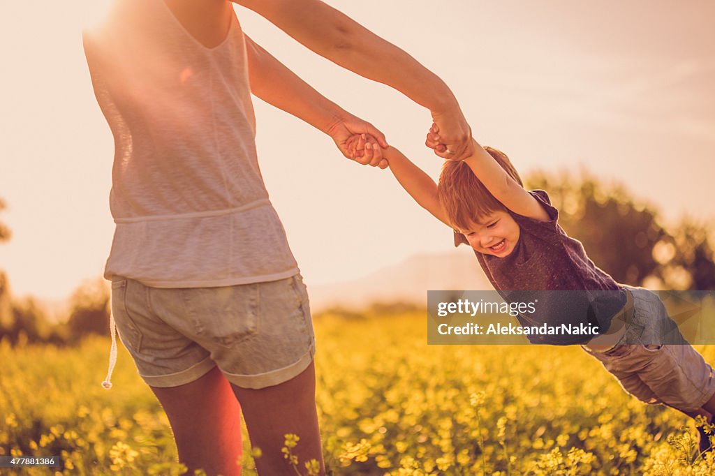 Mother and baby boy having fun at the field