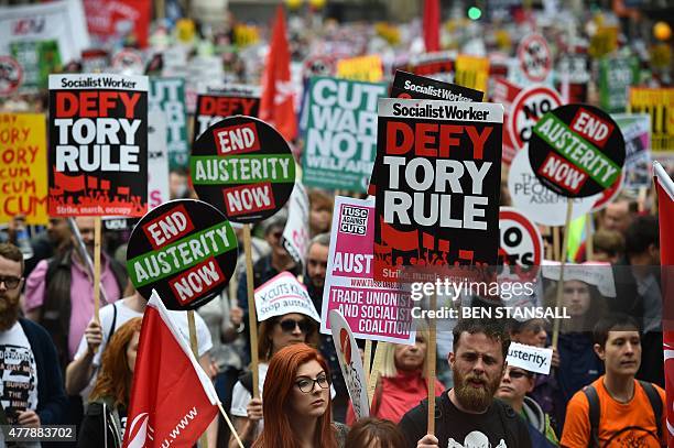 Demonstrators march to protest against the British government's spending cuts and austerity measures in London on June 20, 2015. The national...