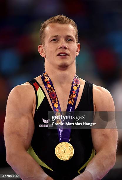 Gold medalist Fabian Hambuechen of Germany poses with the medal won during the Men's Gymnastics Horizontal Bar final on day eight of the Baku 2015...