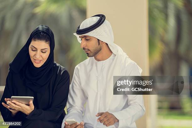 arab students in college campus in conversation - burka stock pictures, royalty-free photos & images