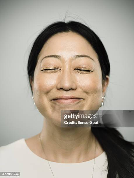 portrait of a young japanese woman with happy smile - satisfaction face stock pictures, royalty-free photos & images