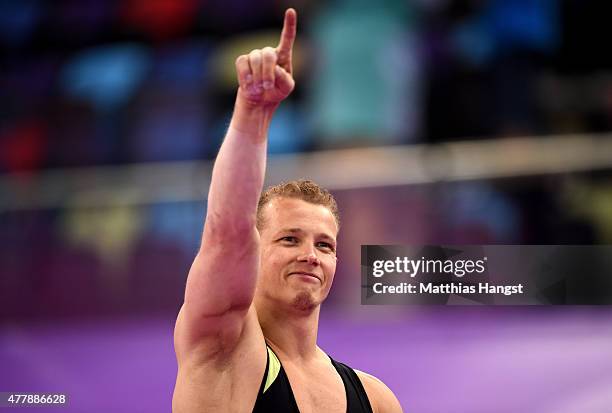 Gold medalist Fabian Hambuechen of Germany celebrates prior to receiving the medal won during the Men's Gymnastics Horizontal Bar final on day eight...