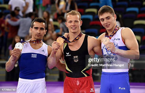 Silver medalist Vlasios Maras of Greece, gold medalist Fabian Hambuechen of Germany and Nikita Ignatyev of Russia pose with the medals won during the...