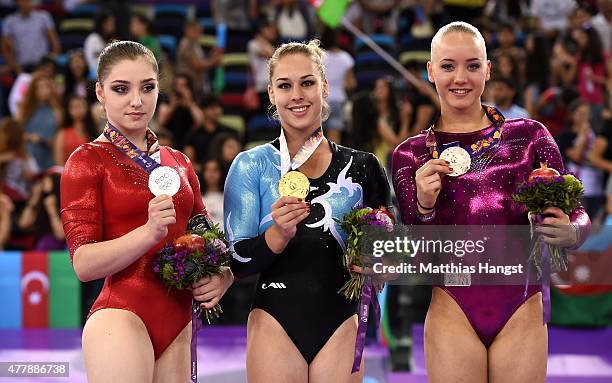 Silver medalist Aliya Mustafina of Russia, gold medalist Giulia Steingruber of Switzerland and bronze medalist Lieke Wevers of the Netherlands pose...