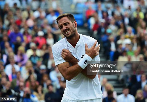 Viktor Troicki of Serbia grimaces after a fall in his men's singles semi-final match against Andy Murray of Great Britain during day six of the Aegon...