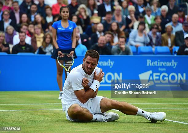 Viktor Troicki of Serbia grimaces after a fall in his men's singles semi-final match against Andy Murray of Great Britain during day six of the Aegon...