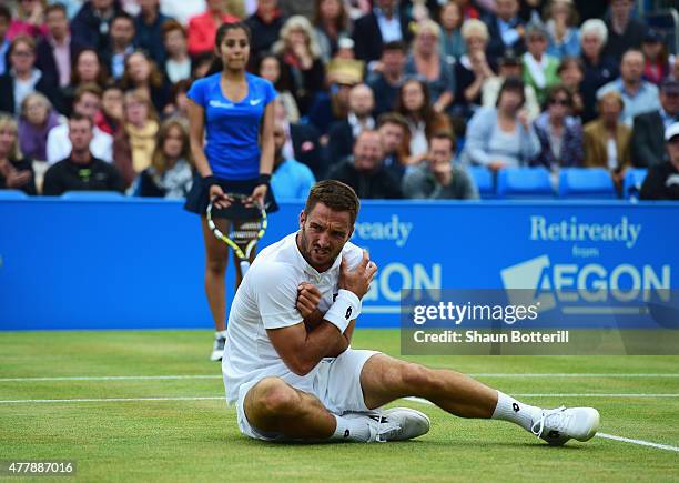 Viktor Troicki of Serbia grimaces after a fall in his men's singles semi-final match against Andy Murray of Great Britain during day six of the Aegon...