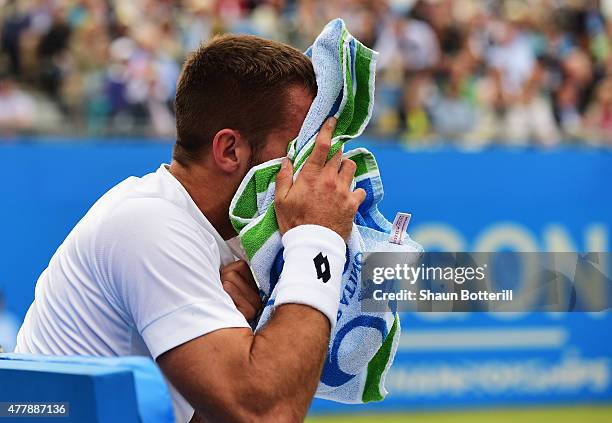 Viktor Troicki of Serbia grimaces after a fall in his men's singles semi-final match against Andy Murray of Great Britain during day six of the Aegon...