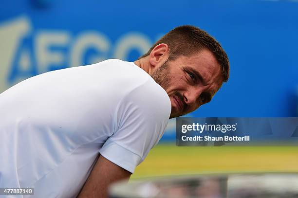 Viktor Troicki of Serbia grimaces after a fall in his men's singles semi-final match against Andy Murray of Great Britain during day six of the Aegon...