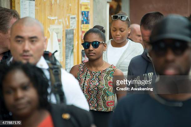 Sasha Obama walks along a canal in Murano on June 20, 2015 in Venice, Italy. Michelle Obama has travelled to Italy where she is expected to speak...