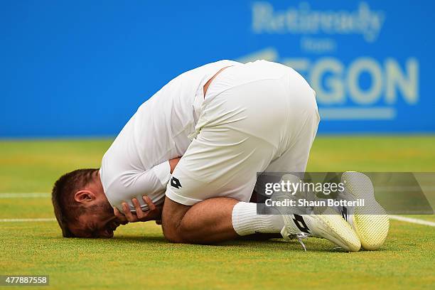 Viktor Troicki of Serbia grimaces after a fall in his men's singles semi-final match against Andy Murray of Great Britain during day six of the Aegon...