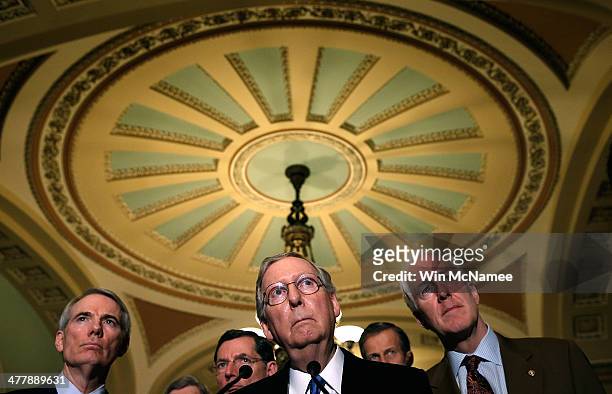 Sen. Mitch McConnell answers questions following a weekly policy luncheon at the U.S. Capitol on March 11, 2014 in Washington, DC. Also pictured are...