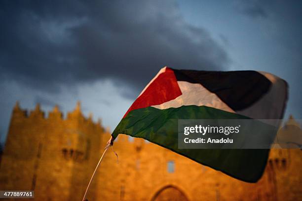 Palestinian flag flies during a protest against the Israeli security forces' act that killed a Palestinian on March 10, in Jerusalem, Israel on March...