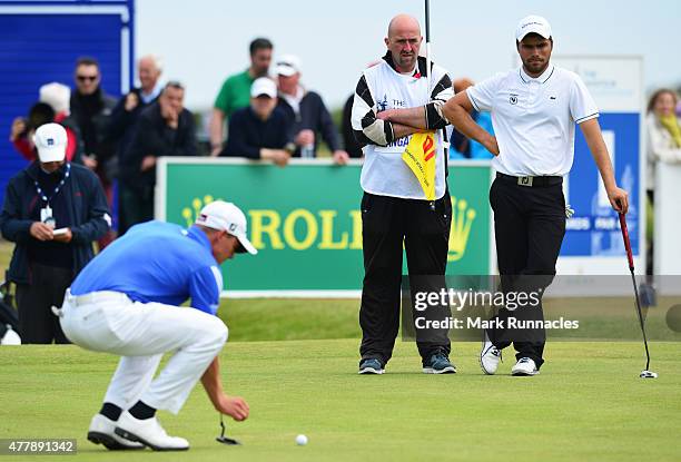 Romain Langasque of France watches Grant Forrest lining up a putt during day Six of the Amateur Championship 2015 at Carnoustie Golf Links on June...