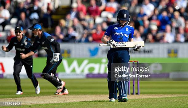 England batsman Eoin Morgan leaves the field after being dismissed first ball as wicketkeeper Luke Ronchi and Kane Wwilliamson celebrate during the...
