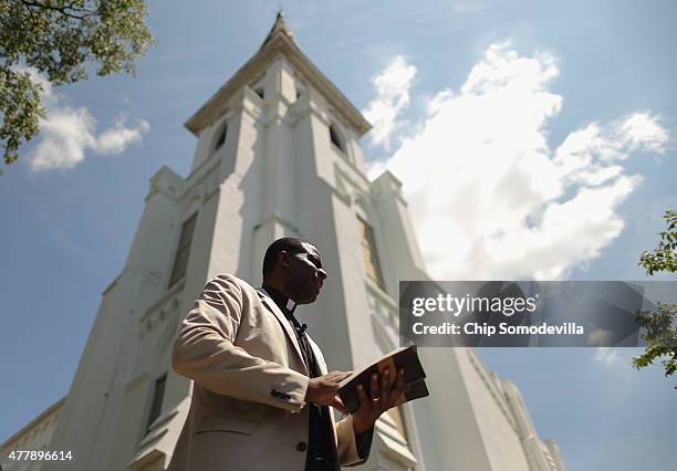 Pastor Dimas Salaberrios of the Infinity Bible Church in New York leads prayers outside the historic Emanuel African Methodist Church where nine...