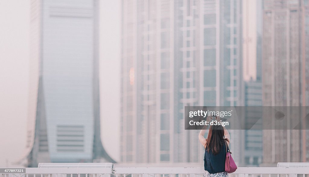 Office ladytaking photo with smartphone