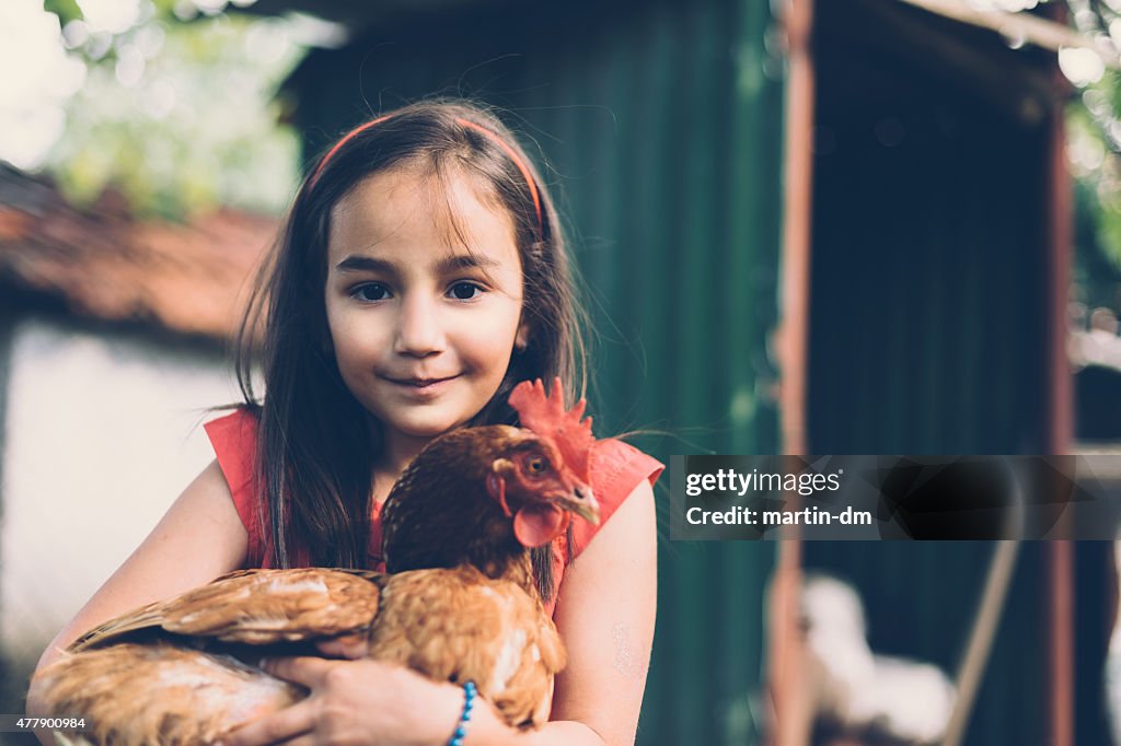 Girl holding a hen