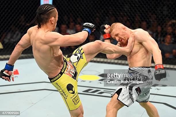 Tatsuya Kawajiri of Japan lands a kick to the chest of Dennis Siver of Germany in their featherweight bout during the UFC Fight Night event at the O2...