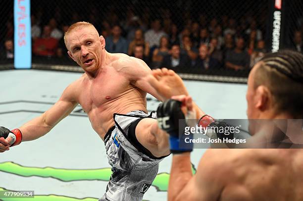 Dennis Siver of Germany kicks Tatsuya Kawajiri of Japan in their featherweight bout during the UFC Fight Night event at the O2 World on June 20, 2015...
