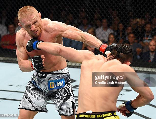 Tatsuya Kawajiri of Japan lands a punch to the face of Dennis Siver of Germany in their featherweight bout during the UFC Fight Night event at the O2...