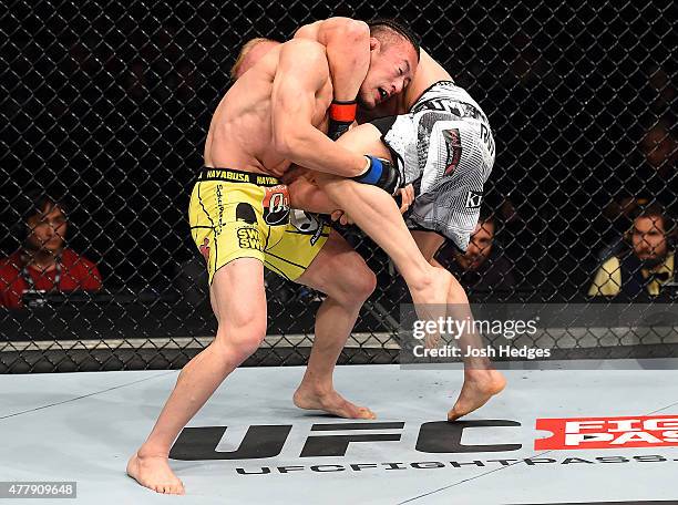 Tatsuya Kawajiri of Japan attempts a takedown against Dennis Siver of Germany in their featherweight bout during the UFC Fight Night event at the O2...